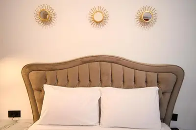 a bedroom with a bed with two mirrors on the wall at Plaka Suite Next to Acropolis by Zeus Suites in Athens