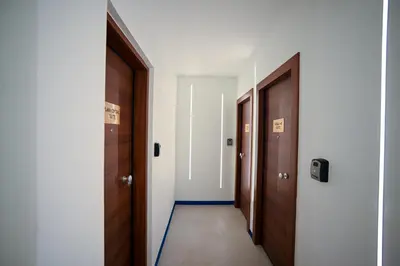 an empty corridor with two doors and a hallway at Plaka Suite Next to Acropolis by Zeus Suites in Athens