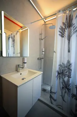 a bathroom with a sink and a shower curtain at Plaka Suite Next to Acropolis by Zeus Suites in Athens