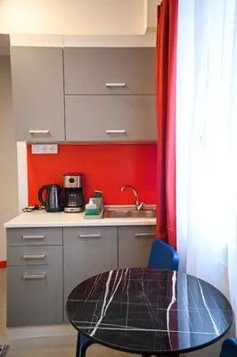 a small kitchen with a table and a sink at Plaka Suite Next to Acropolis by Zeus Suites in Athens