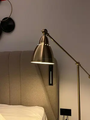 a metal lamp sitting next to a couch at Muses Suite Klathmonos by Zeussuites in Athens