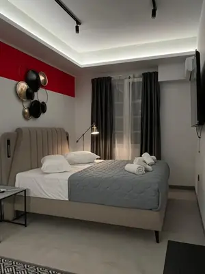 a bedroom with a bed with two towels on it at Muses Suite Klathmonos by Zeussuites in Athens