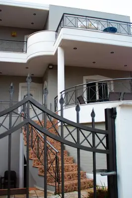 a building with a staircase in front of it at EMVI APARTMENTS VI near airport in Vravrona