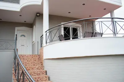 a house with a staircase leading up to the front door at EMVI APARTMENTS VI near airport in Vravrona