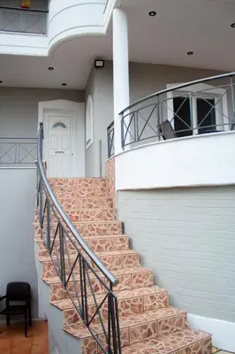 a set of stairs in a building with a white door at EMVI APARTMENTS VI near airport in Vravrona
