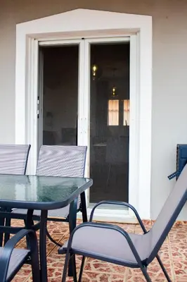 a table and chairs sitting on a patio at EMVI APARTMENTS VI near airport in Vravrona