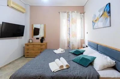 a bedroom with a bed with two towels on it at AIOLOS HABITAT pagrati apartment ATHENS in Athens