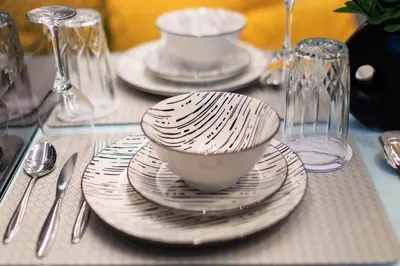 a table with plates and silverware on a table at AIOLOS HABITAT pagrati apartment ATHENS in Athens