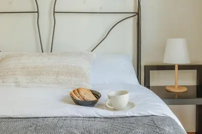 a bowl of bread and a cup of coffee on a bed at Urban cozy penthouse with city view in Athens