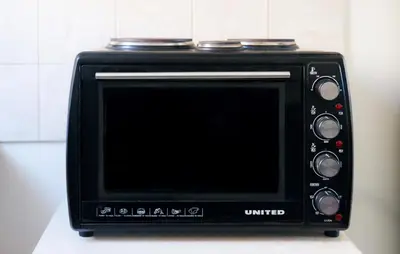 a black microwave oven sitting on top of a counter at Urban cozy penthouse with city view in Athens