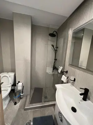 a bathroom with a sink and a shower and a toilet at Stylish Condo Nearby Acropolis & Metro in Athens