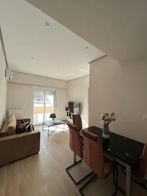 a living room with a couch and a table at Stylish Condo Nearby Acropolis & Metro in Athens
