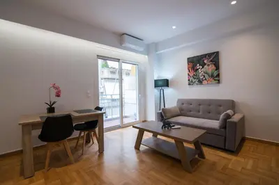 a living room with a couch and a table at Arie Central Apartments by Live & Travel in Athens