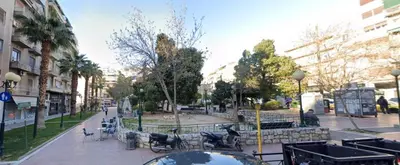 a city street with a park with a fountain at Arie Central Apartments by Live & Travel in Athens
