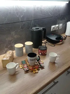 a table with three cups and some snacks on it at Elegant Minimalistic Downtown Apartment! in Athens