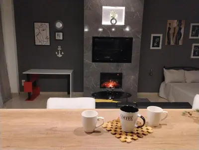 a living room with two coffee cups on a table at Elegant Minimalistic Downtown Apartment! in Athens