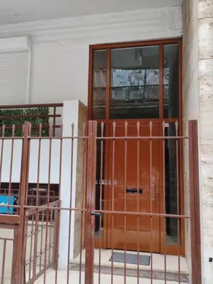 a wooden door in front of a building at Elegant Minimalistic Downtown Apartment! in Athens