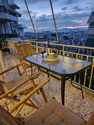 a table on a balcony with a bottle of wine at Little Acropolis in Athens