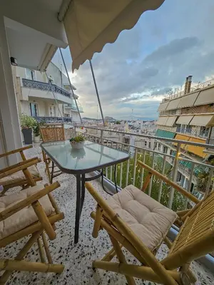 a balcony with a table and chairs and an umbrella at Little Acropolis in Athens