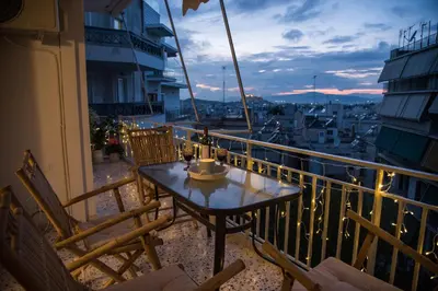 a table on a balcony with a view of a city at Little Acropolis in Athens