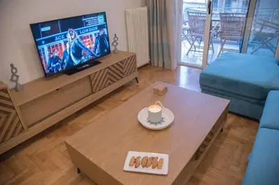 a living room with a tv and a coffee table at Little Acropolis in Athens