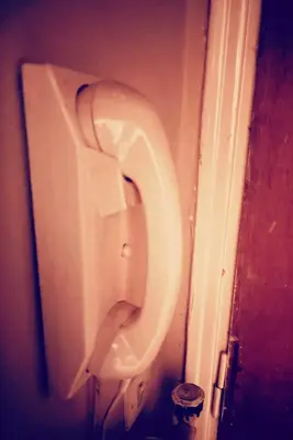 a urinal on a wall in a bathroom at Quiet Arty Cosy Cool Flat Downtown in Athens