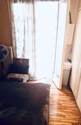 a bedroom with a bed and a large window at Quiet Arty Cosy Cool Flat Downtown in Athens