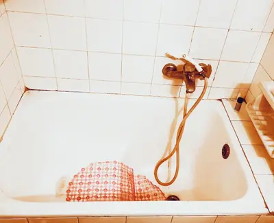 a bath tub with a copper faucet in a bathroom at Quiet Arty Cosy Cool Flat Downtown in Athens