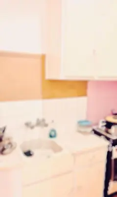 a kitchen with white cabinets and a sink at Quiet Arty Cosy Cool Flat Downtown in Athens