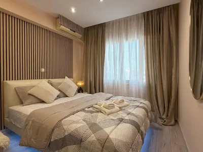 a bedroom with a bed with two towels on it at Heart of Athens, right next to Syntagma Square in Athens