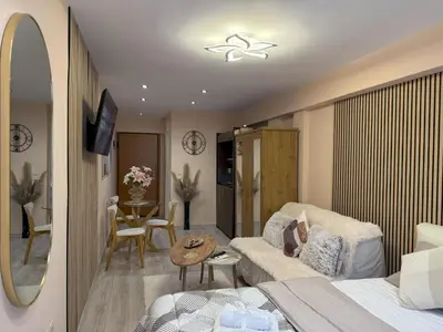 a living room with a bed and a couch and a table at Heart of Athens, right next to Syntagma Square in Athens