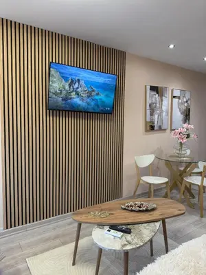 a living room with a table and a striped wall at Heart of Athens, right next to Syntagma Square in Athens