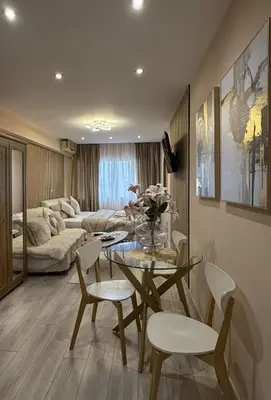 a living room with a table and chairs and a couch at Heart of Athens, right next to Syntagma Square in Athens