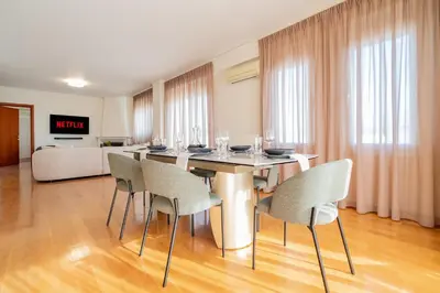 a dining room with a table and chairs at Elegant Skyline Penthouse Acropolis View 3BR 2BA in Athens