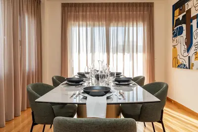 a dining room with a table and chairs at Elegant Skyline Penthouse Acropolis View 3BR 2BA in Athens
