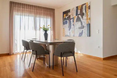 a dining room with a table and chairs at Elegant Skyline Penthouse Acropolis View 3BR 2BA in Athens