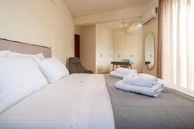 a bedroom with a large white bed with towels on it at Elegant Skyline Penthouse Acropolis View 3BR 2BA in Athens