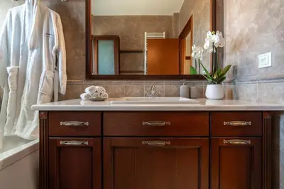 a bathroom with a sink and a mirror at Elegant Skyline Penthouse Acropolis View 3BR 2BA in Athens