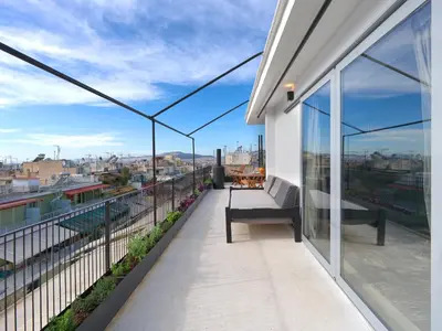 a balcony with a bench and views of the city at Athens at your feet - Modern Loft with a view in Athens