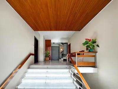a hallway with stairs with a wooden ceiling at Athens at your feet - Modern Loft with a view in Athens