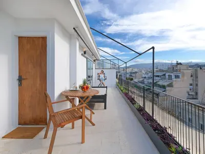 a balcony with a table and a view of a city at Athens at your feet - Modern Loft with a view in Athens