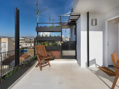 a balcony with two chairs and a view of a city at Athens at your feet - Modern Loft with a view in Athens