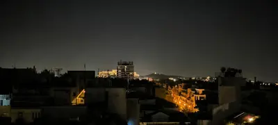 a view of a city at night with buildings at Athens at your feet - Modern Loft with a view in Athens