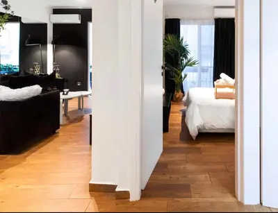 a white room with a bedroom and a bed at Novel Acropolis Apartment in Athens