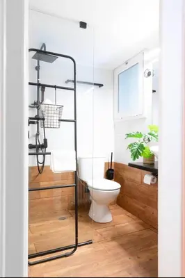 a bathroom with a toilet and a glass shower at Novel Acropolis Apartment in Athens