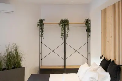 a room with a bed and plants on a wall at Syntagma Serenity Suites in Athens