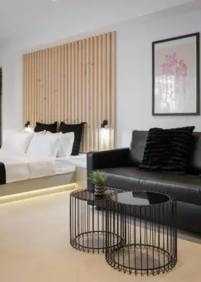 a living room with a couch and a bed at Syntagma Serenity Suites in Athens