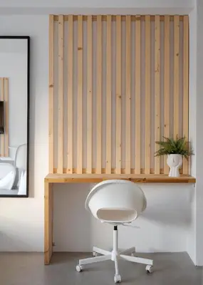 a white chair sitting under a wooden desk at Syntagma Serenity Suites in Athens