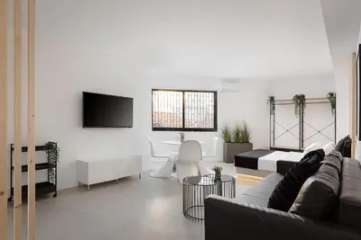 a living room with a couch and a tv at Syntagma Serenity Suites in Athens