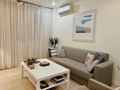 a living room with a couch and a table at Elegant apartment in Kolonaki in Athens